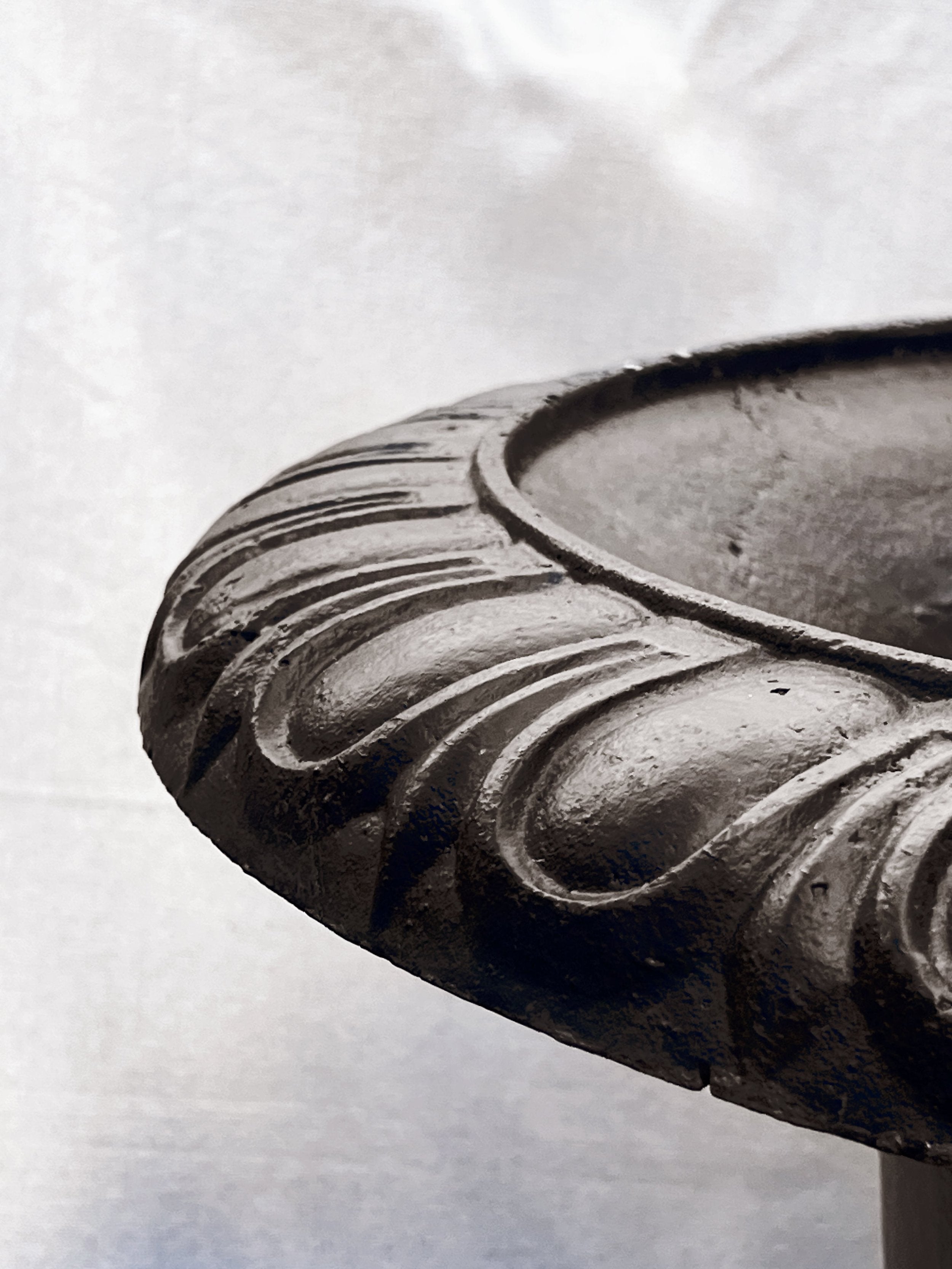 Detailed view of the rim of a Pair of 29" French Cast Iron Urn Black Planters showcasing intricate design. hommes + gardens estudio.