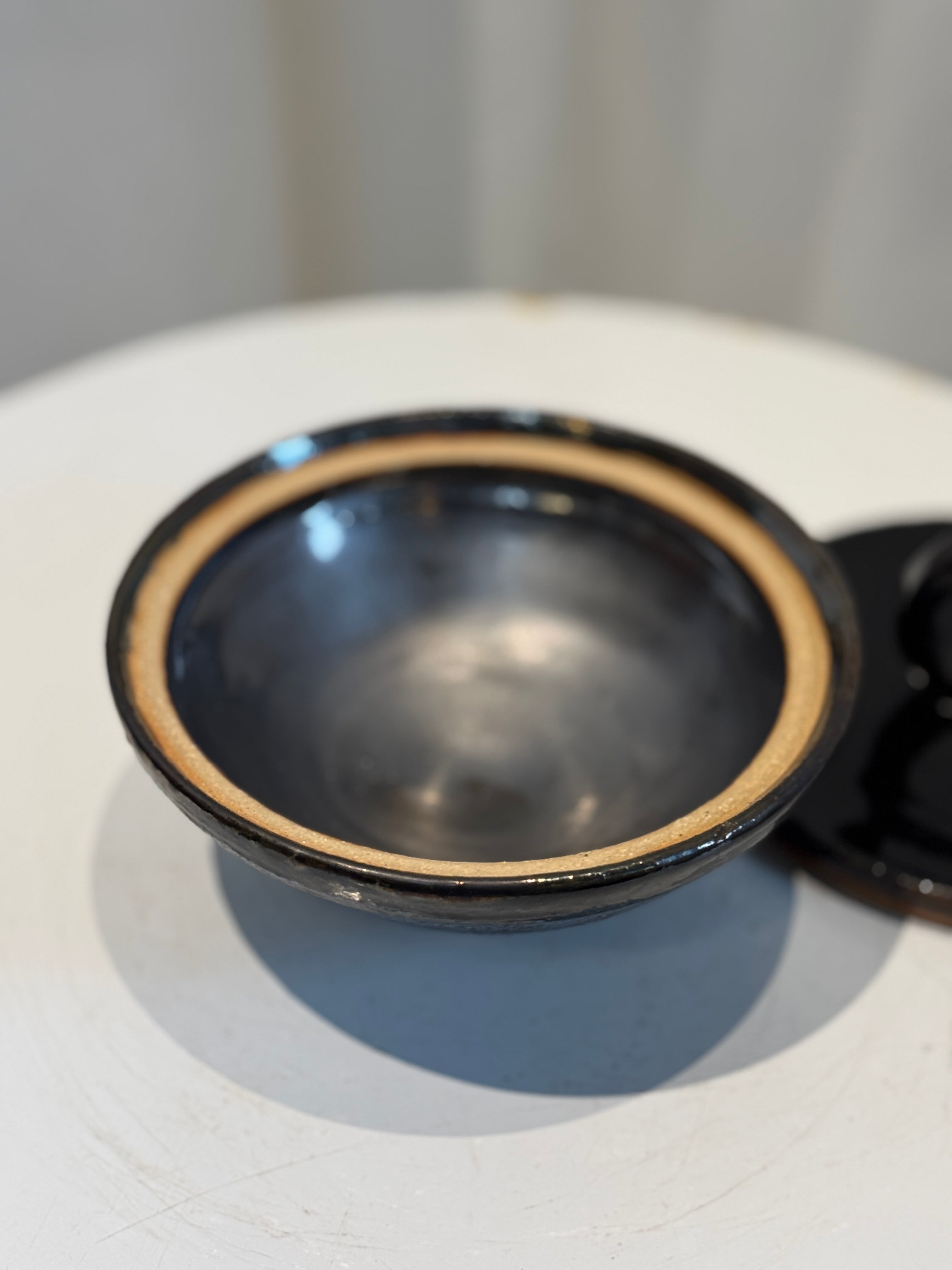 Vintage black glazed ceramic lidded bowl with sculptural ring handle, featuring glossy finish and rustic clay accents, a perfect collectible decor piece — Hommes and Gardens, Catchall Collection, Landscape Architect, Interior Designer, Outdoor Living, Art, Furniture, Objects, Best Gifts, Nature, Backyard, Yard, Outdoor Decorations, Home Decor, Home Design, Luxury Design.