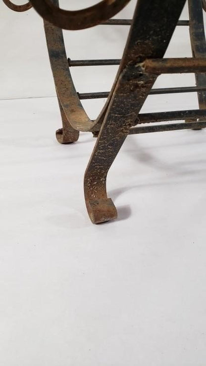 Vintage black wrought iron firewood carrier combining strength and elegance, a decorative yet practical accent for rustic and traditional interiors — Hommes and Gardens, Home Decor Collection, Firewood Holders, Decorative Objects, Vintage Fireplace Decor, Iron Craft, Rustic Home Accessory, Antique Hearth Design, Classic Interior Styling.