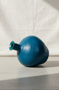 VINTAGE BLUE STONEWARE VASE on a neutral background showcasing its unique shape and rich blue color. hommes + gardens estudio.
