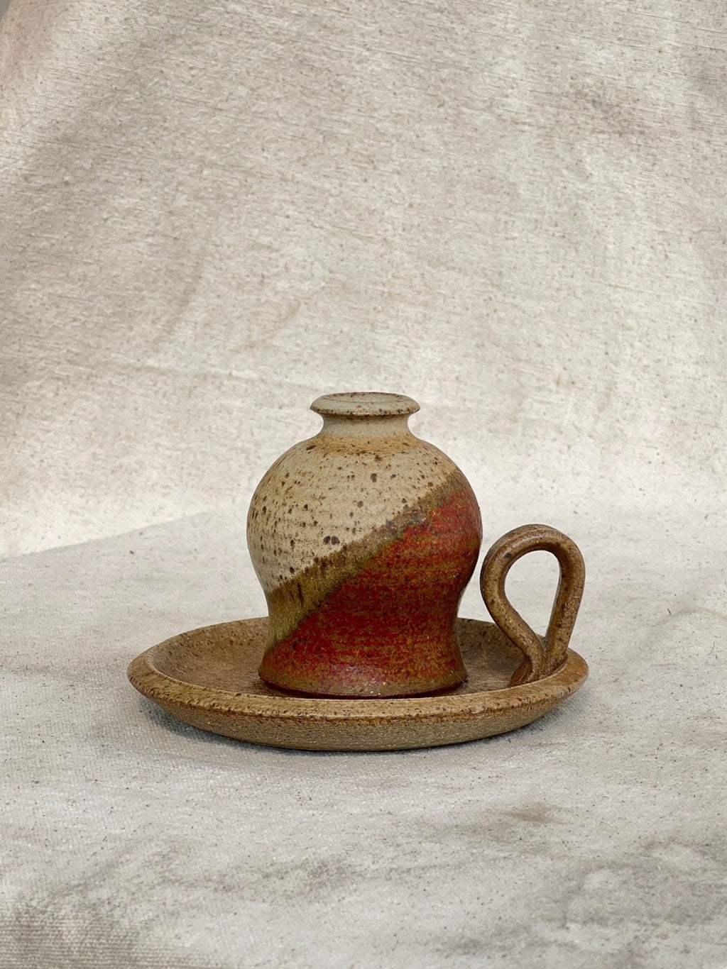 Vintage Chamber Stick Candle Holder Glazed Stoneware on a textured background, adding warmth and character to home decor. hommes + gardens estudio.