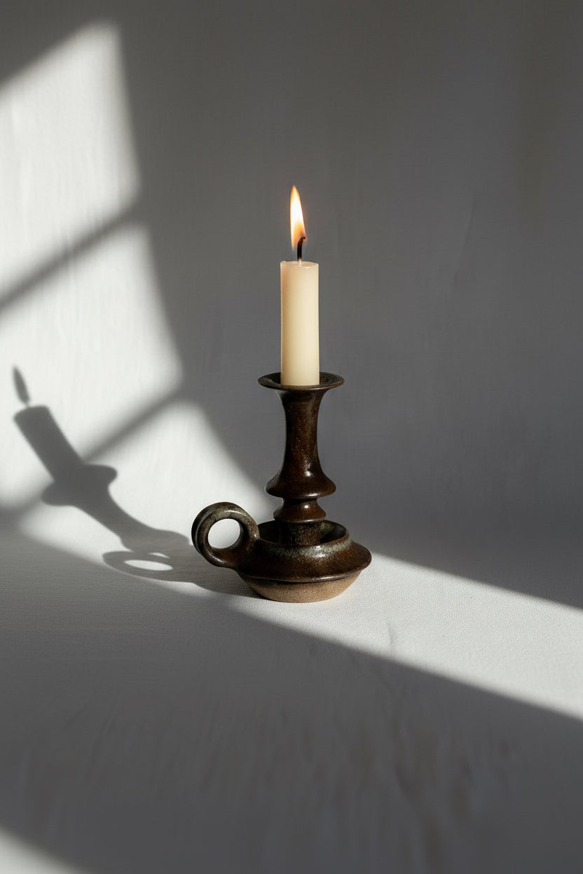 Vintage Brown Ceramic Stoneware Candle Holder with candle and soft shadows, perfect for home decor accents. hommes + gardens estudio.
