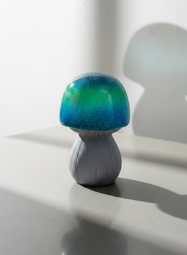 Vintage Ceramic Garden Mushroom with vibrant green and blue hues, adding a whimsical touch to your garden. hommes + gardens estudio