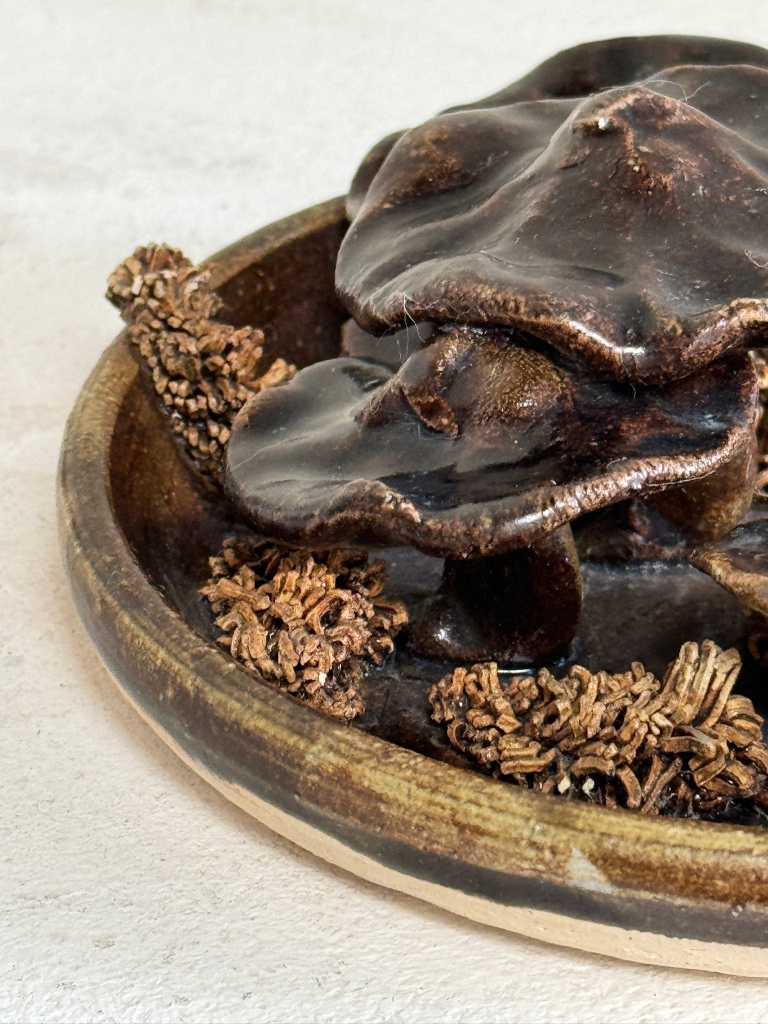 Close-up of a vintage ceramic mushroom centerpiece with brown fungi candle holder and coral bowls, part of the Set of 3: Vintage ceramic mushroom centerpiece + Ceramic brown fungi candle holder +Small porcelain coral bowl. hommes + gardens estudio.
