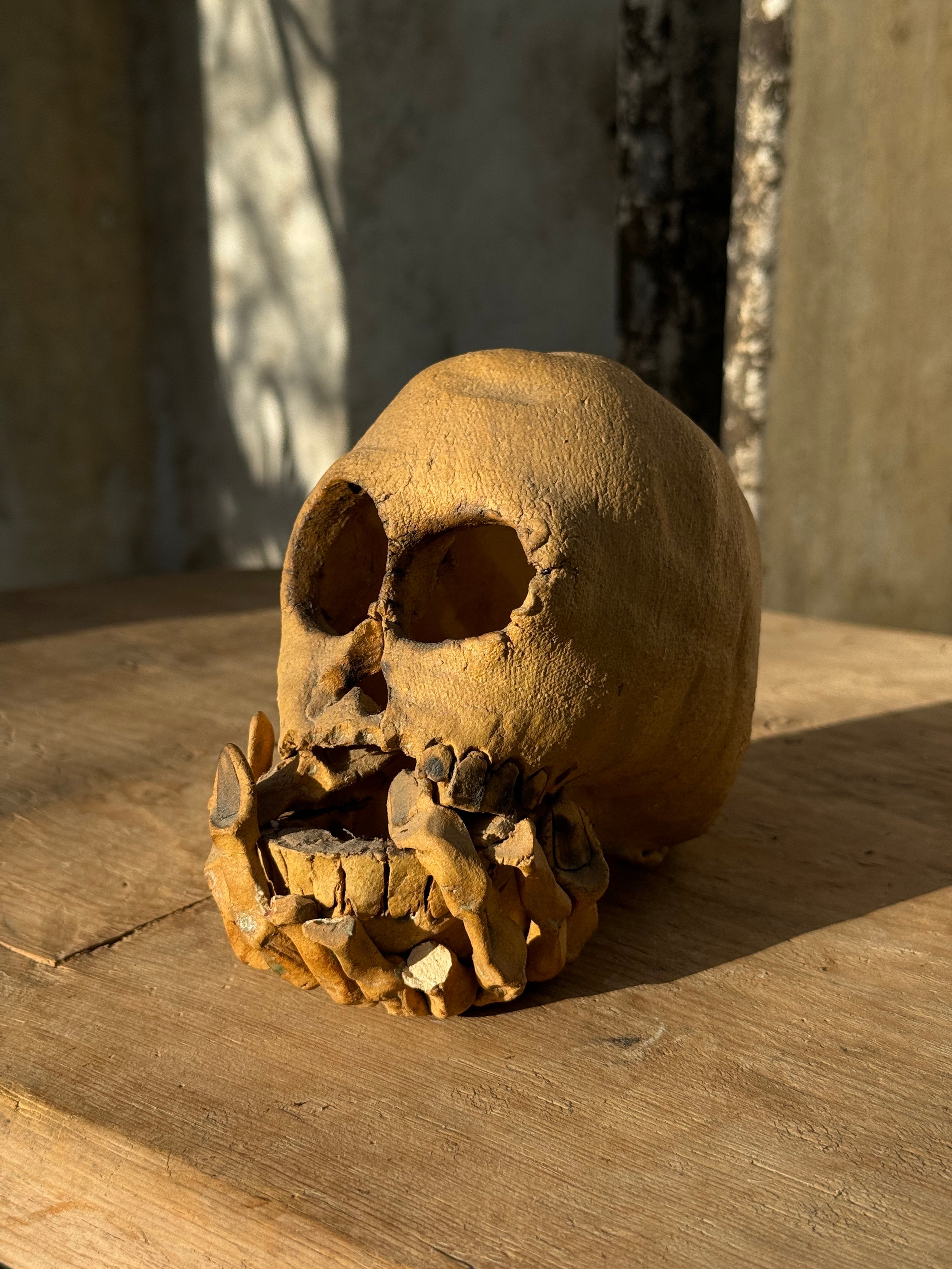 Vintage ceramic skull candle holder with clasped hand design and artistic finish, blending gothic charm and modern artistry — Hommes and Gardens, home decor, outdoor decorations, home design, luxury design, Landscape Architect, Interior Designer, Outdoor Living, Art, Furniture, Objects, Best Gifts, Nature, Backyard, Yard.