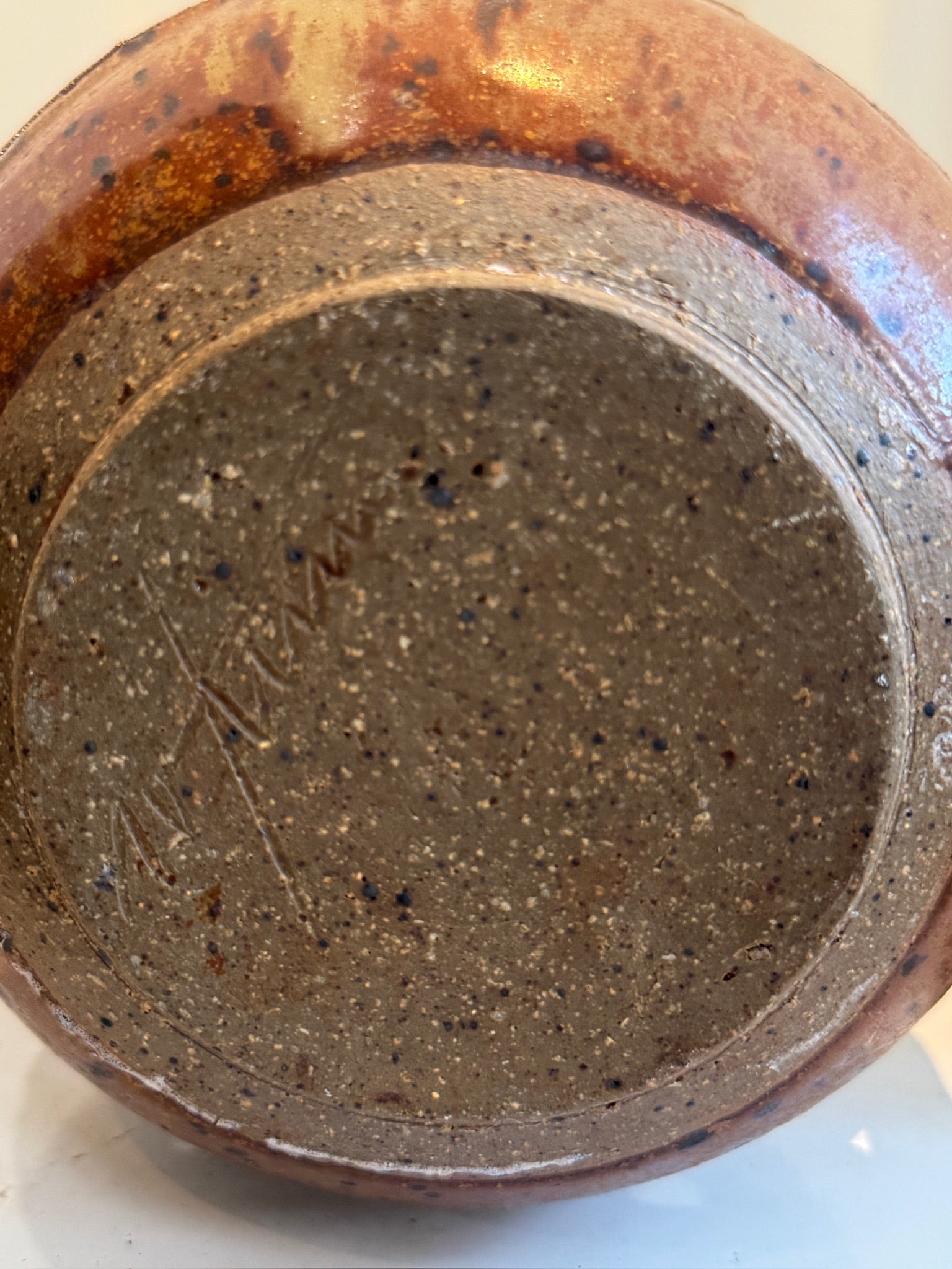 Bottom view of a Vintage Ceramic Vase with Lid and Geometric Cutout Design, showcasing its textured surface and signature. hommes + gardens estudio.