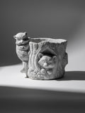 Vintage Concrete Animal Planter featuring an owl and raccoon design, perfect for adding charm to any garden decor. hommes + gardens estudio.
