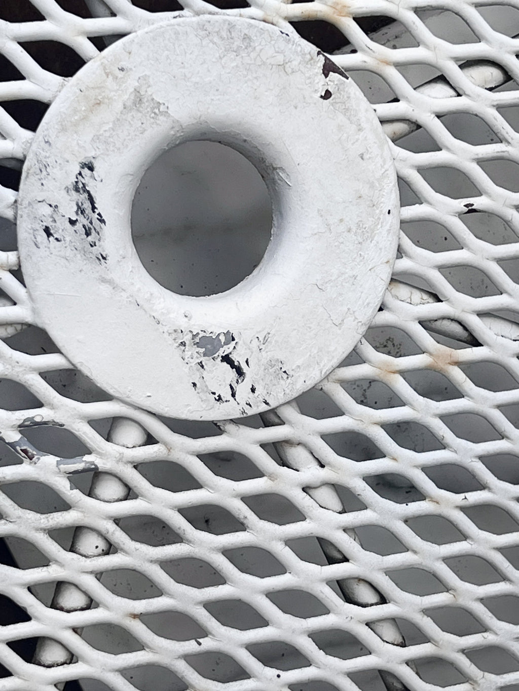 Close-up of the vintage white wrought iron pattern on the Vintage Woodard Wrought Iron Patio Set Briarwood "Daisy Barrel" Patio Table & Chairs. hommes + gardens estudio.