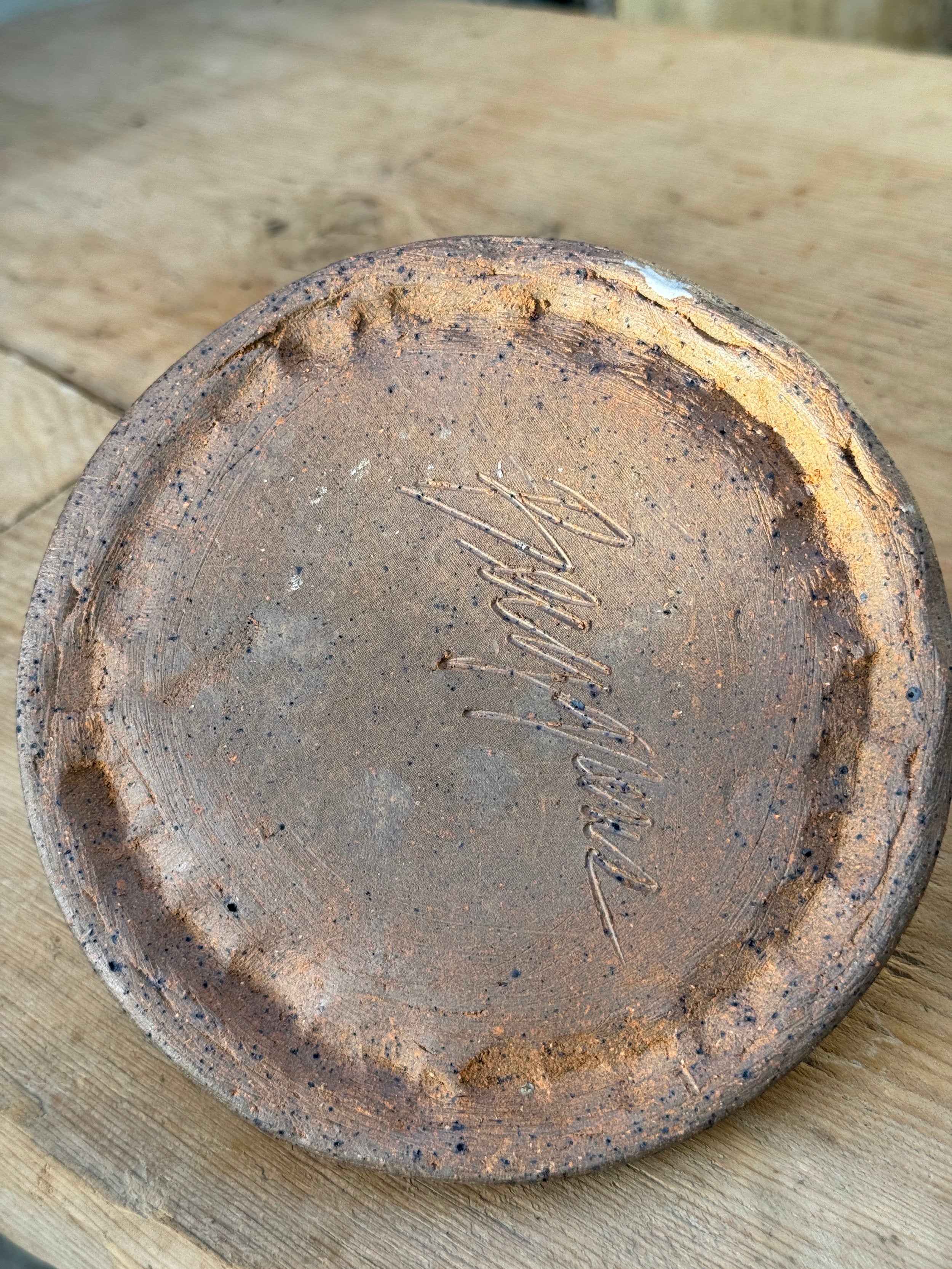 Underside view of Vintage Hand Crafted Unglazed Flat Oil Lamp with Etched Wheat (Signed) showing signature detail. hommes + gardens estudio.