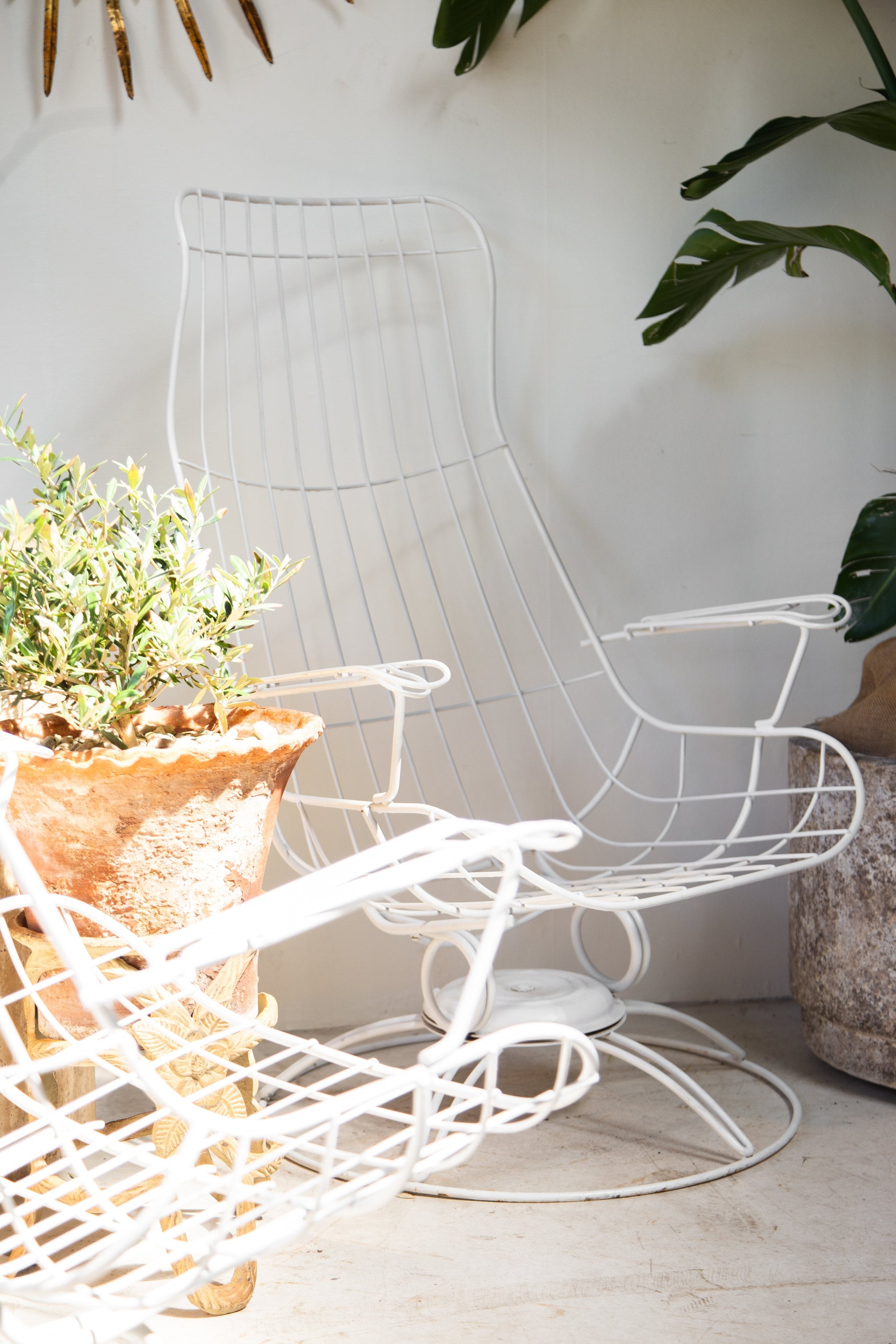 Pair of Mid-Century Modern Homecrest Siesta Swivel Rocker Patio Lounge Chairs in white finish with greenery and natural decor. hommes + gardens estudio.