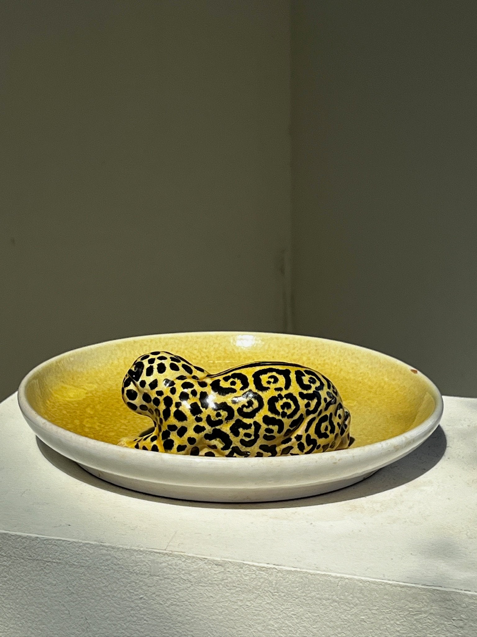 Vintage Italian Ceramic Yellow Platter with Jaguar Figurine on display, showcasing intricate artistry and sophistication. hommes + gardens estudio.