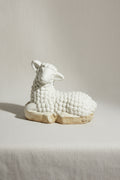Vintage Laying Lamb Stoneware Figurine rests elegantly, showcasing intricate details of its serene design. hommes + gardens estudio.