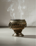 Vintage Metal Incense Urn with swirling smoke, showcasing its intricate design and vintage appeal. hommes + gardens estudio.
