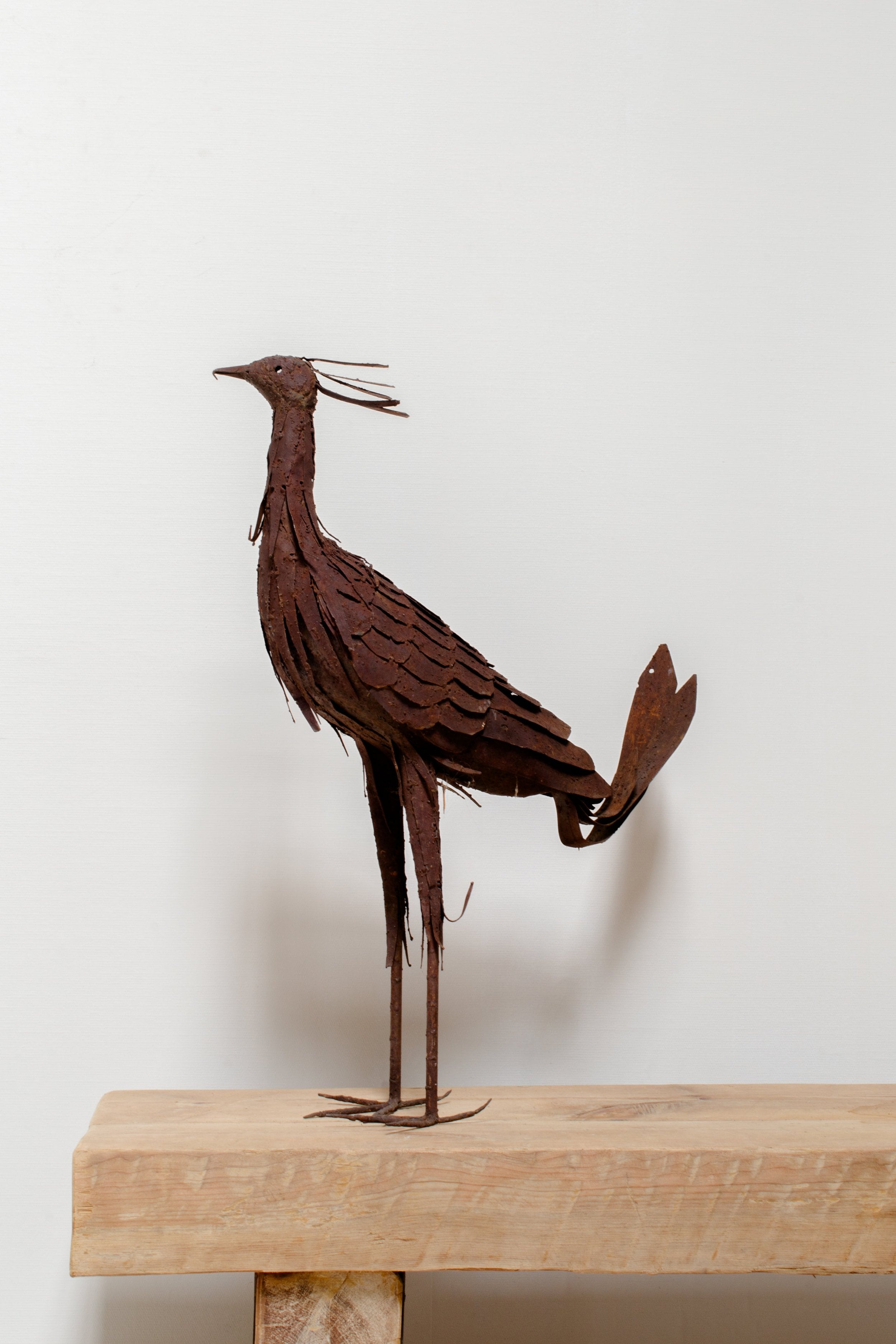 Vintage Heavy-Gauge Metal Peacock sculpture, showcasing intricate details and vintage charm, perfect for elegant decor. hommes + gardens estudio.