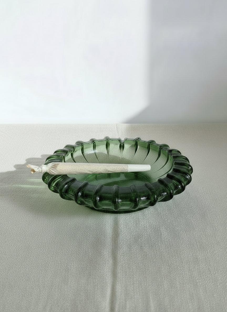Vintage Mid century green glass ashtray with sunburst pattern and vibrant green hue, hommes + gardens estudio.