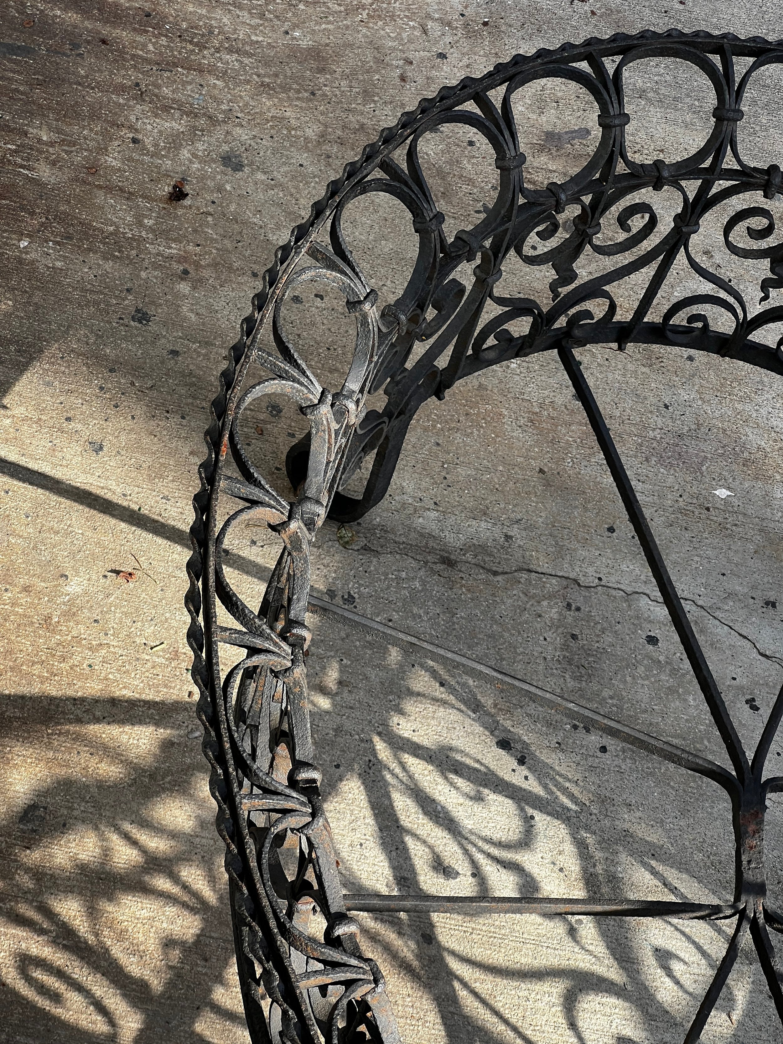 Victorian Oval Wrought Iron Plant Holder showcasing decorative scrollwork and natural patina. hommes + gardens estudio.
