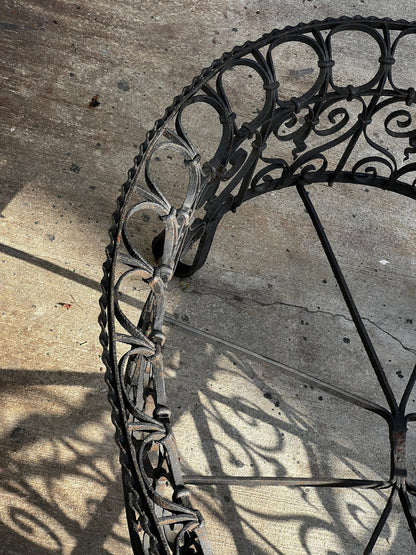 Vintage oval wrought iron plant holder with decorative scrollwork and dark weathered finish, a timeless French-inspired garden accessory — Hommes and Gardens, Furniture Collection, Plant Cages & Supports, Vintage Outdoor Furniture, Antique Metalwork, Rustic Garden Decor, Botanical Display Stand.