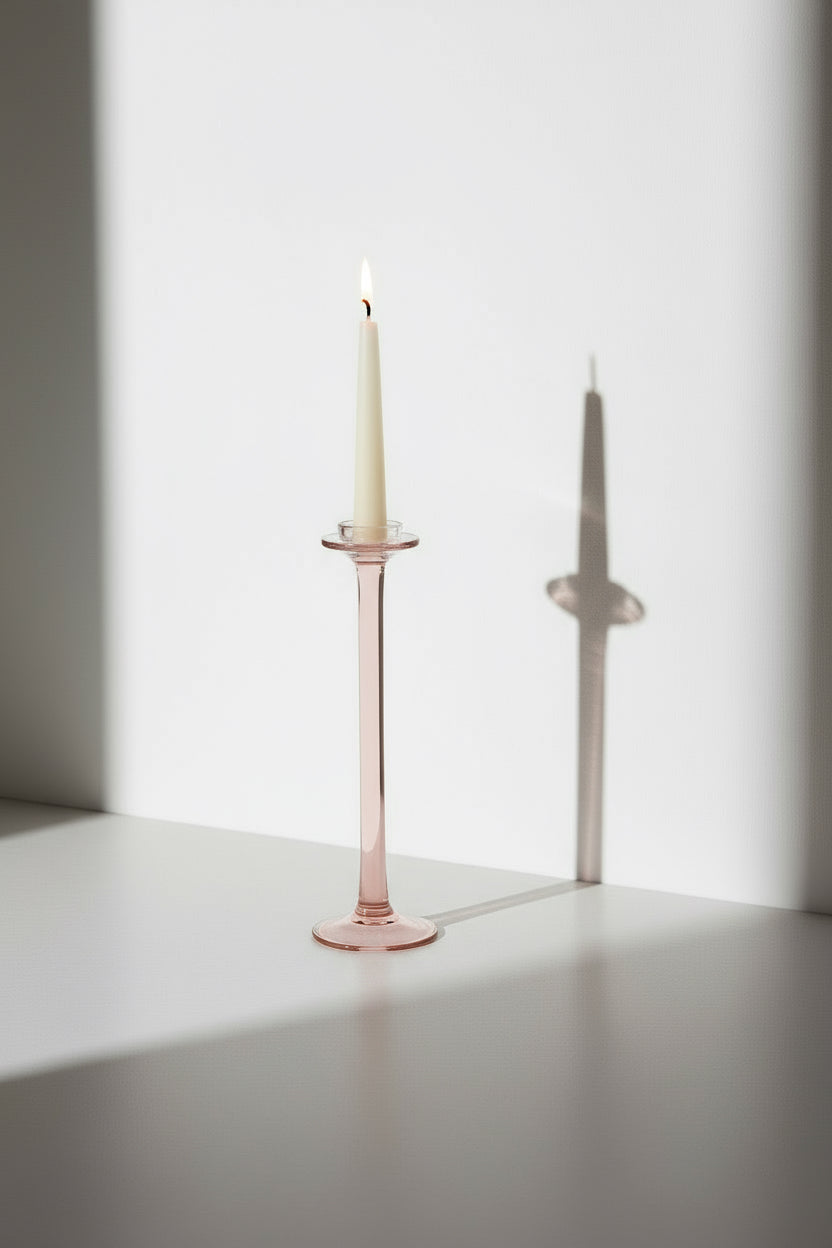 Elegant Vintage Pink Glass Candle Holder with white candle, showcasing soft rosy hue and charming design. hommes + gardens estudio.