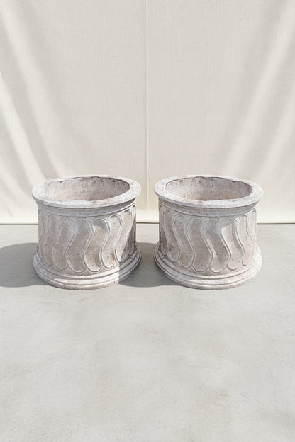Set of two vintage round Roman style swirl planters featuring elegant classical patterns and weathered stone texture, perfect for timeless garden design — Hommes and Gardens, Pots and Vessels Collection, Planters, Garden Decor, Outdoor Living, Vintage Stonework, Classical Design, Architectural Garden Accent, Outdoor Planter Set.