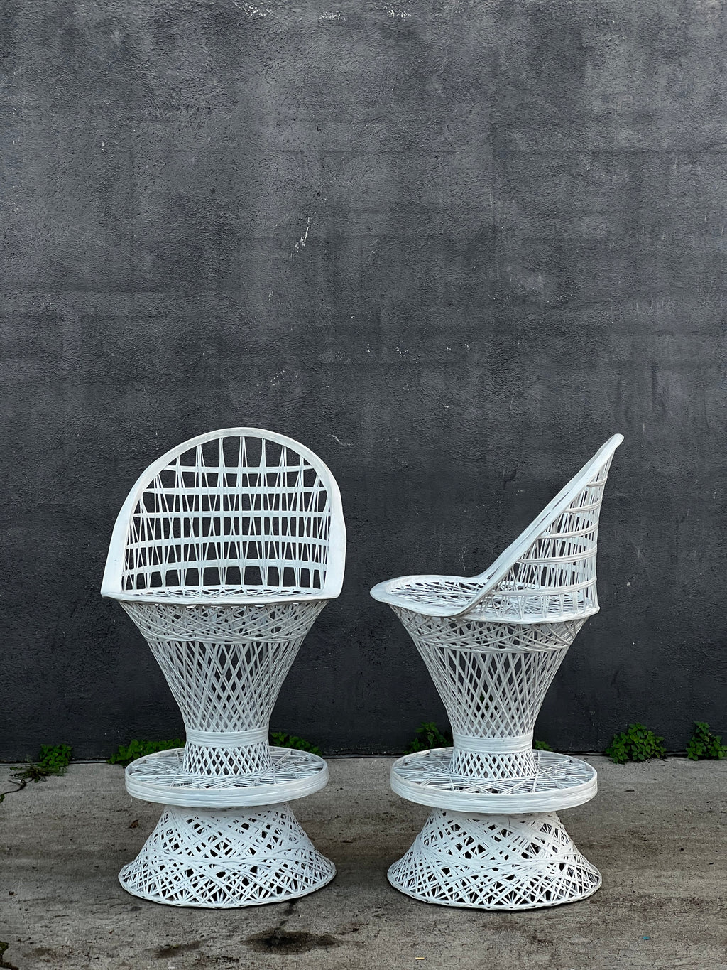 Pair of Russell Woodard Spun Fiberglass Bar Stools against a gray wall, showcasing their timeless design. hommes + gardens estudio.
