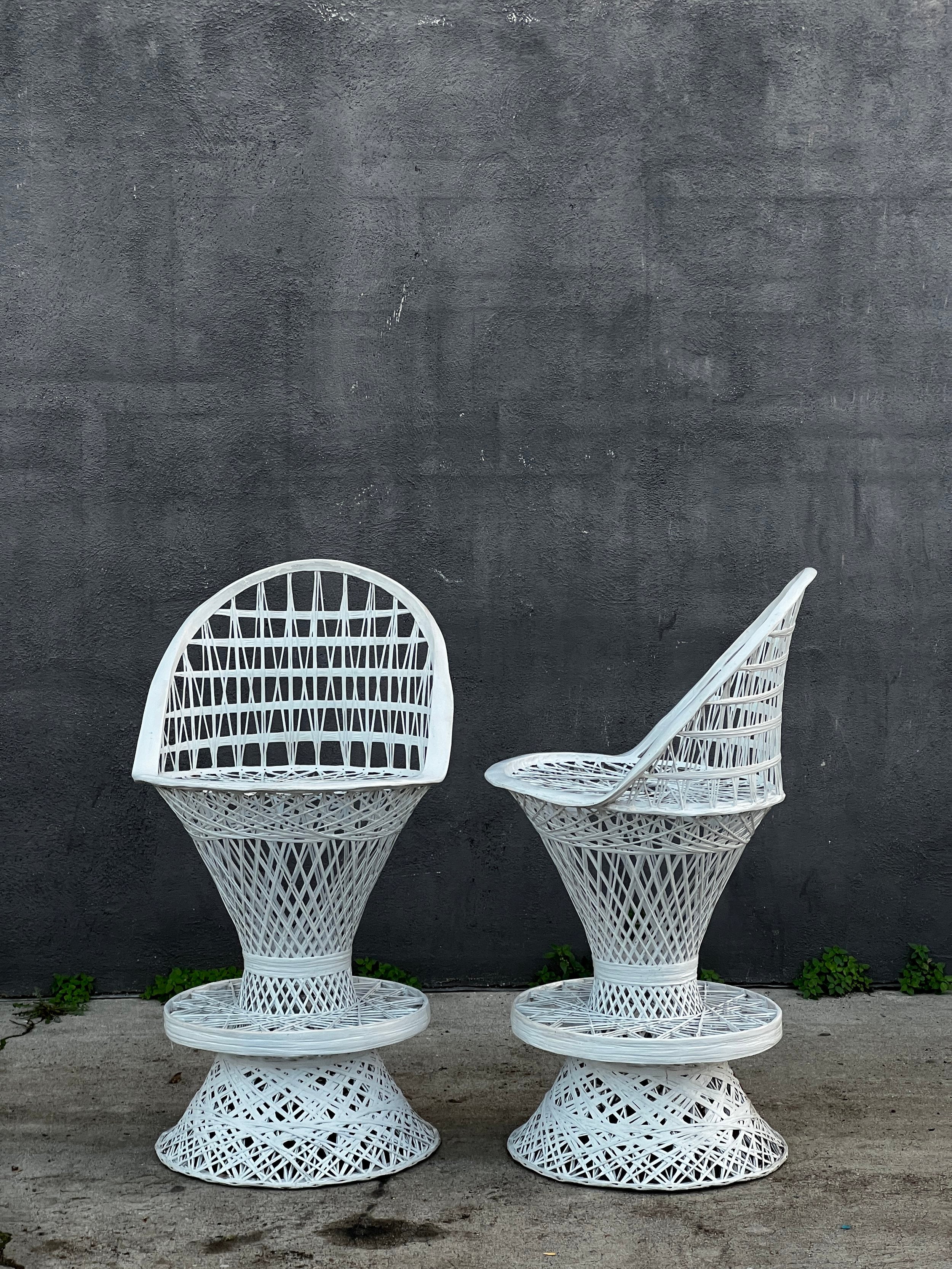 Pair of Russell Woodard Spun Fiberglass Bar Stools against a gray wall, showcasing their timeless design. hommes + gardens estudio.