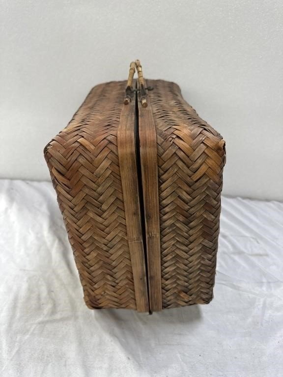 Vintage bamboo travel or picnic case showcasing its rustic woven design and sturdy build for outdoor adventures. hommes + gardens estudio