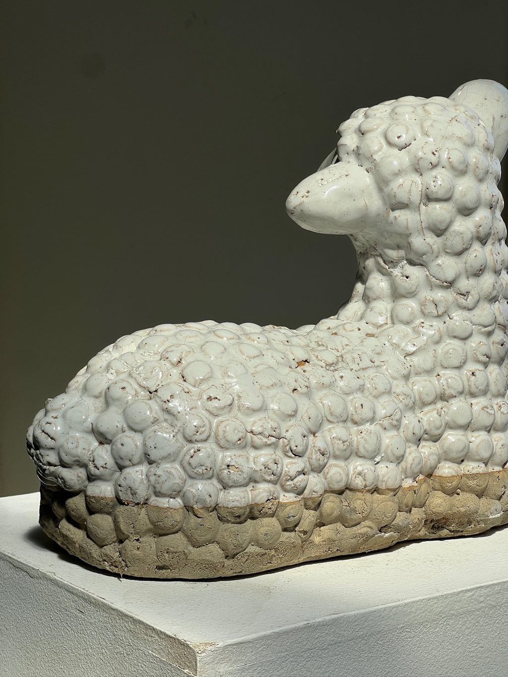 Vintage Laying Lamb Stoneware Figurine side view on display highlighting detailed texture and craftsmanship. hommes + gardens estudio.
