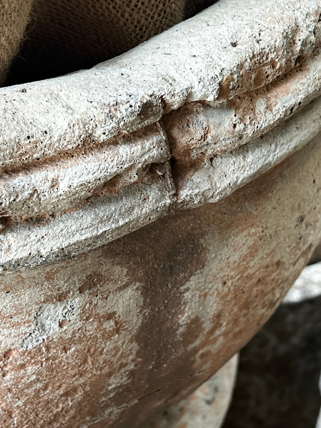 Close-up detail of the Vintage Sevilla Stone Planter w/ Pedestal showcasing its aged texture and craftsmanship. hommes + gardens estudio.
