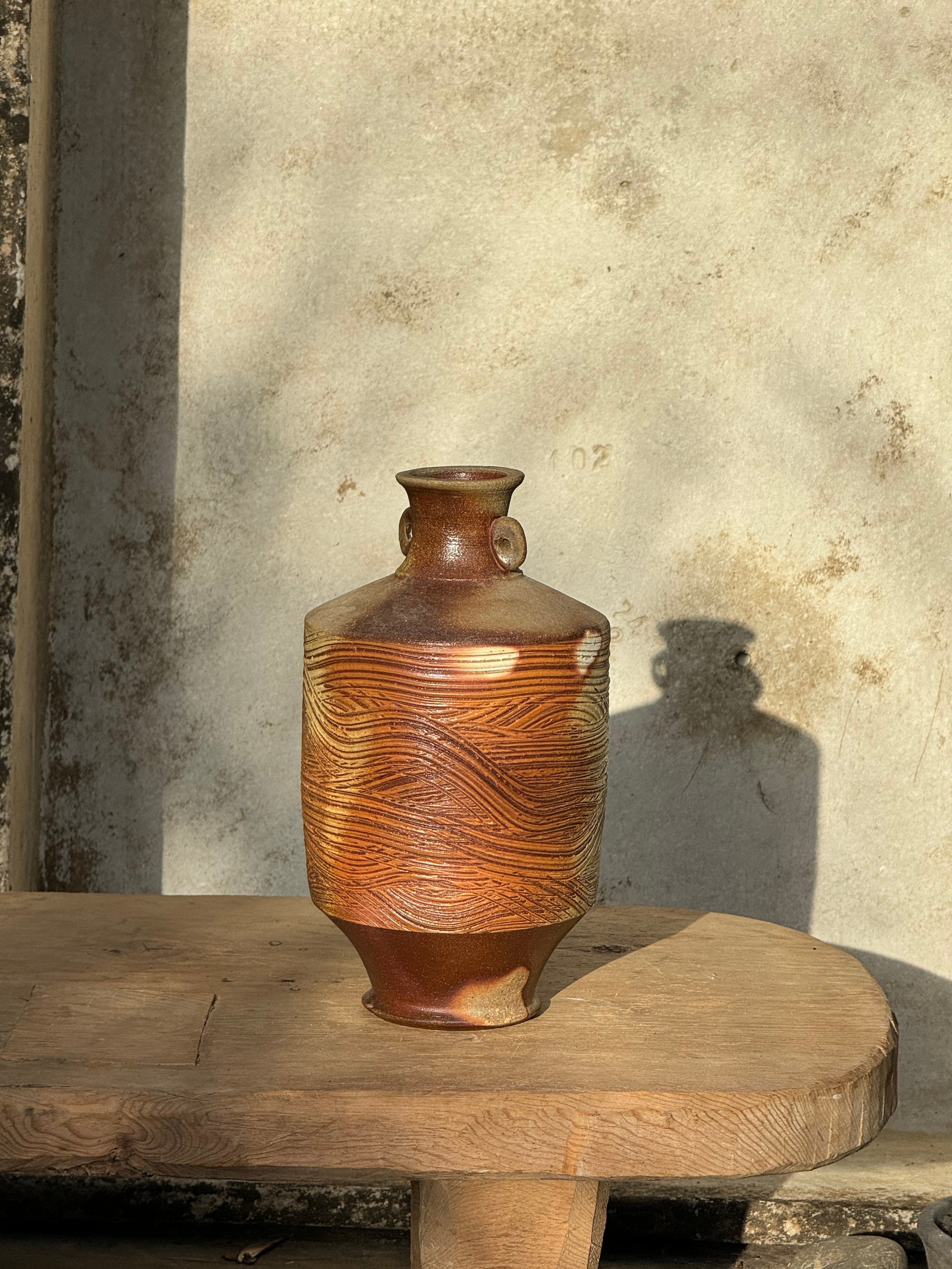 Vintage Brown Wooden Grain Etched Salt Glazed Stoneware Jug with Handles Signed displayed on a wooden table, showcasing rustic charm. hommes + gardens estudio.