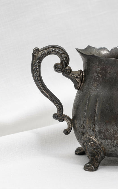 Vintage silver plated creamer pitcher from Hong Kong with footed base and elegant spout, perfect for refined interiors — Hommes and Gardens, Home Decor Collection, Silver Decor, Decorative Tableware, Luxury Accent, Vintage Metalware, Classic Styling.