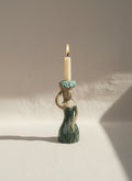 Vintage Stoneware Hungarian Mermaid Figurine Candle Holder with a lit candle, showcasing coastal decor charm. hommes + gardens estudio.