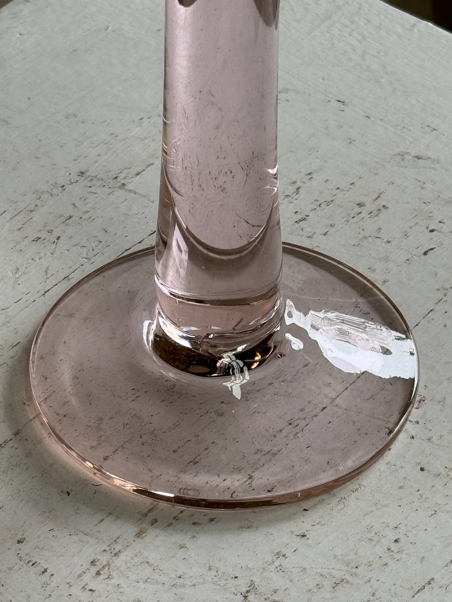 Close-up of the base of a Vintage Pink Glass Candle Holder showcasing its elegant design and soft rosy hue. hommes + gardens estudio.