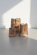 Vintage Tapio Wirkkala Rosenthal Iconic "Tutenvase" Paper Bag Vase Collection (Set of 3) displayed on a minimalist surface. hommes + gardens estudio.