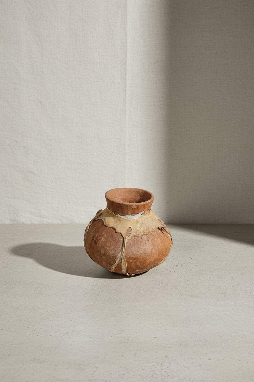 Vintage Tarahumara Pottery Vessel with rawhide lacing and earthy light tan-brown hue, showcasing unique craftsmanship. hommes + gardens estudio.