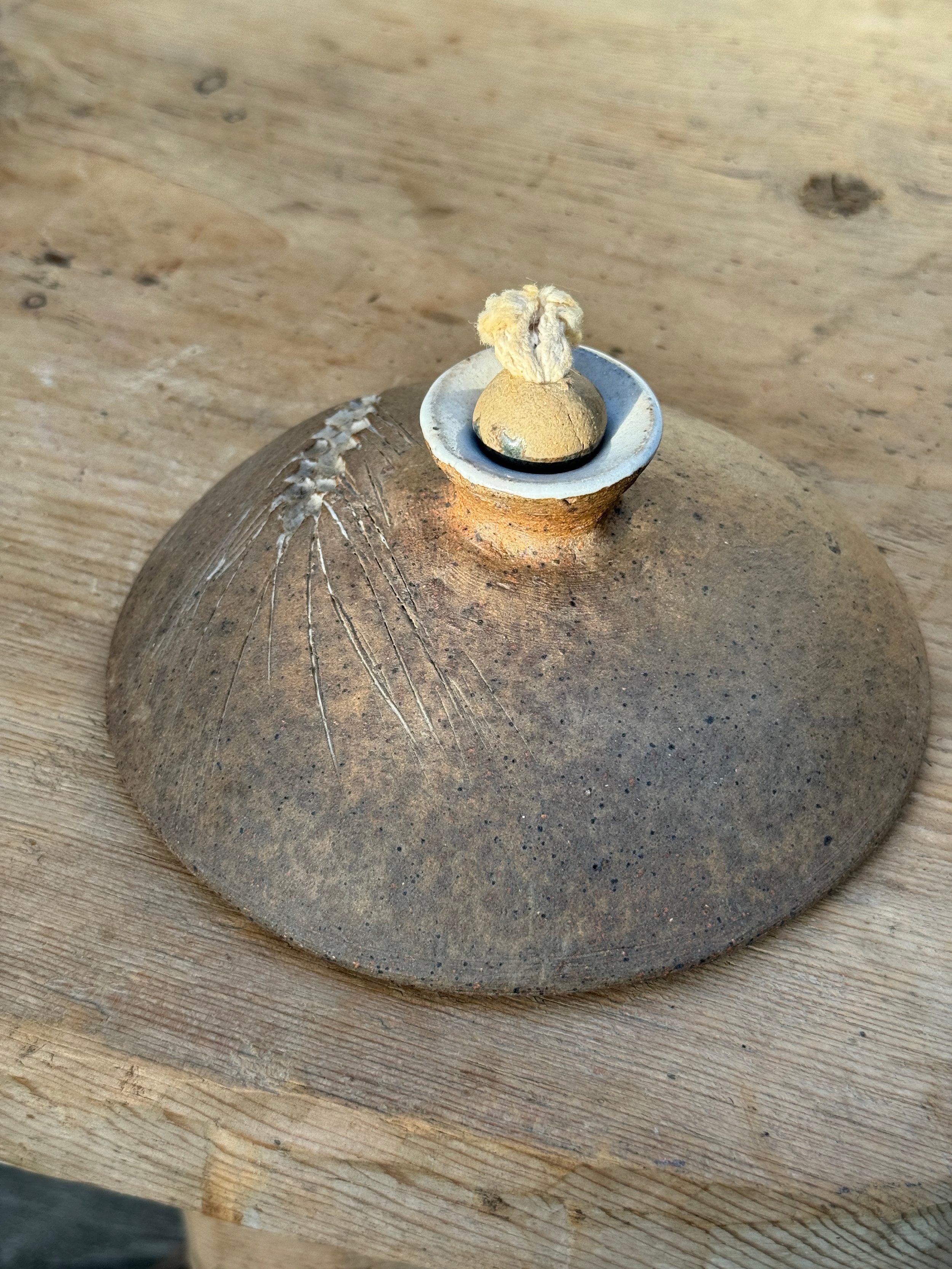 Vintage Hand Crafted Unglazed Flat Oil Lamp with Etched Wheat (Signed) on wooden surface, displaying natural textures. hommes + gardens estudio.