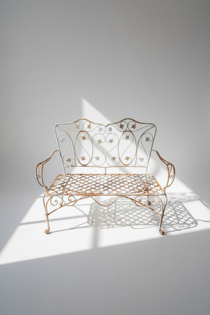 Vintage wrought iron garden bench featuring elegant scrollwork and foliage accents, a timeless outdoor seating piece perfect for patios or rustic garden decor — Hommes and Gardens, Outdoor Seating, Furniture Collection, Garden Decor, Vintage Ironwork, Rustic Home Style, Classic Patio Furniture, Antique Metal Bench, Outdoor Living, Designer Garden Accent.