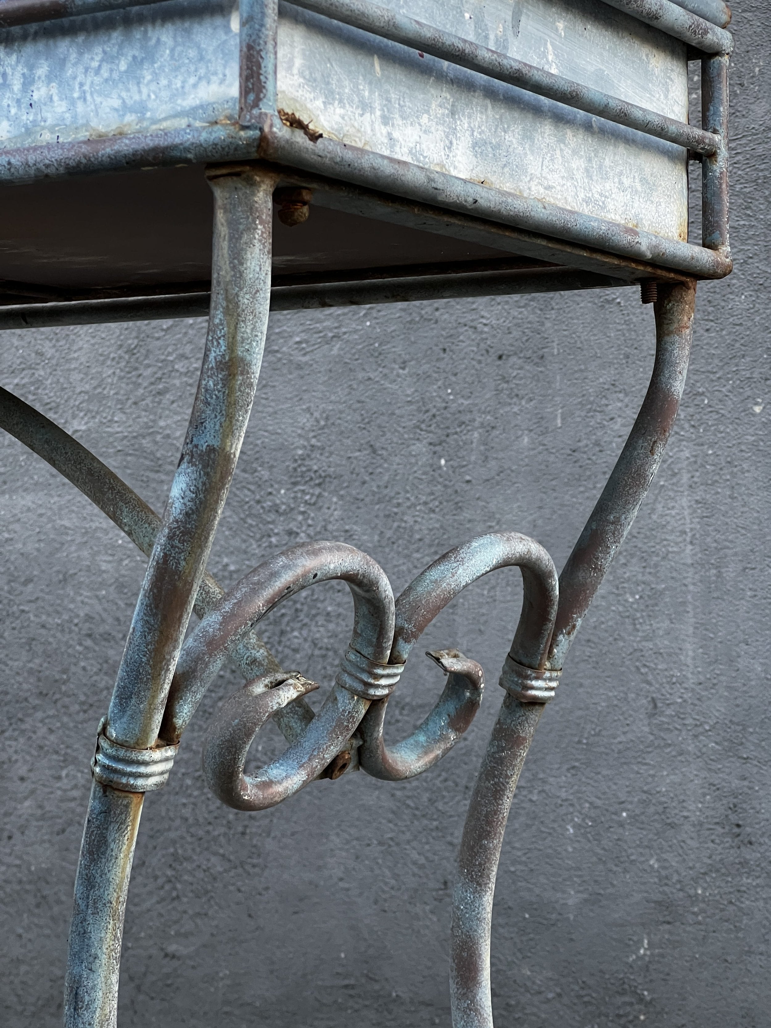 Vintage Arras Style Tall Weathered Metal Plant Stand close-up showing ornate metal detailing and weathered finish, hommes + gardens estudio.