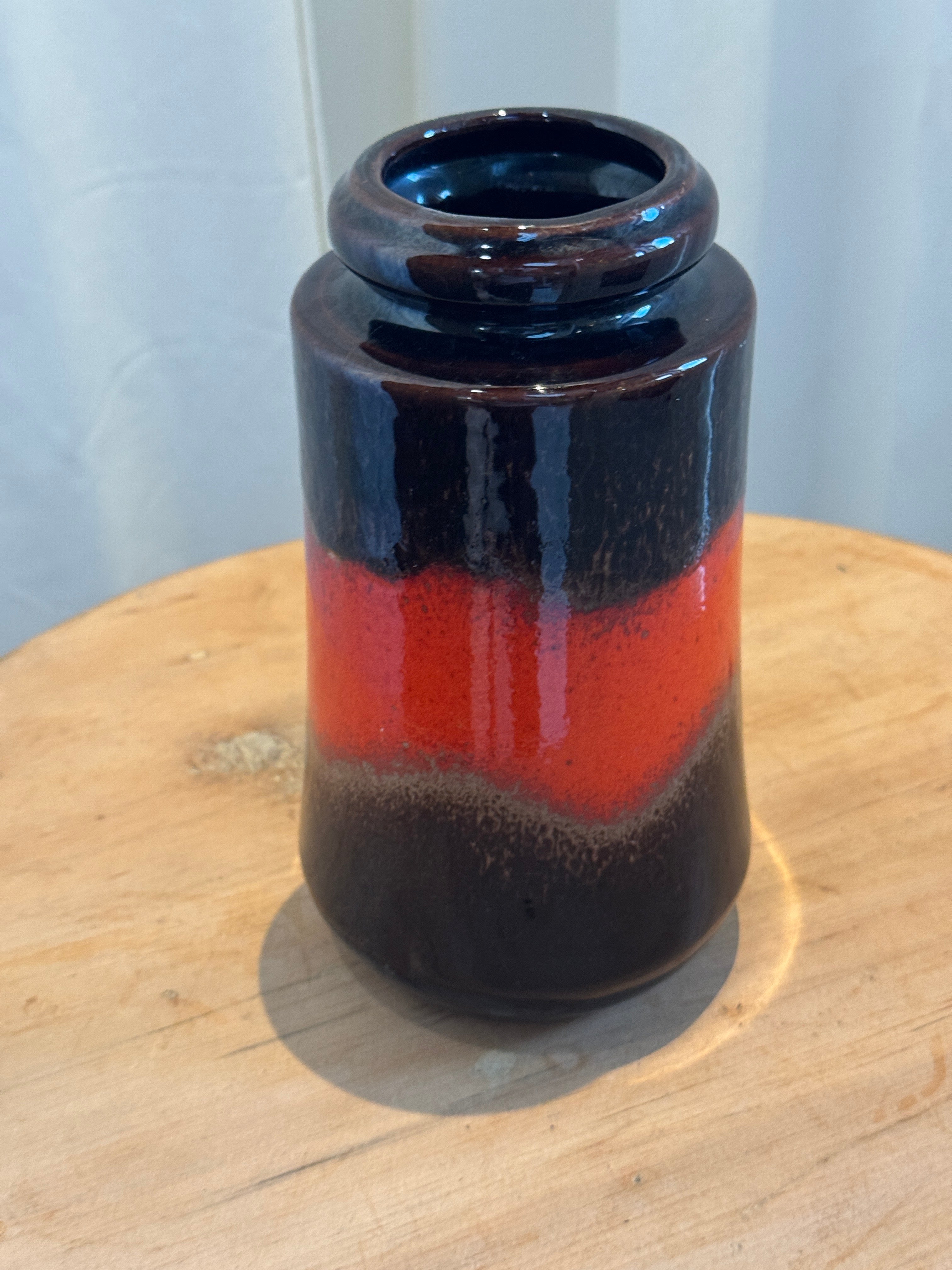 West German Fat Lava ceramic vase with flared base and rounded lip, featuring rich red and brown glaze typical of mid-century art pottery — Hommes and Gardens, Vases + Vessels Collection, Landscape Architect, Interior Designer, Outdoor Living, Art, Furniture, Objects, Best Gifts, Nature, Backyard, Yard, Outdoor Decorations, Home Decor, Home Design, Luxury Design.