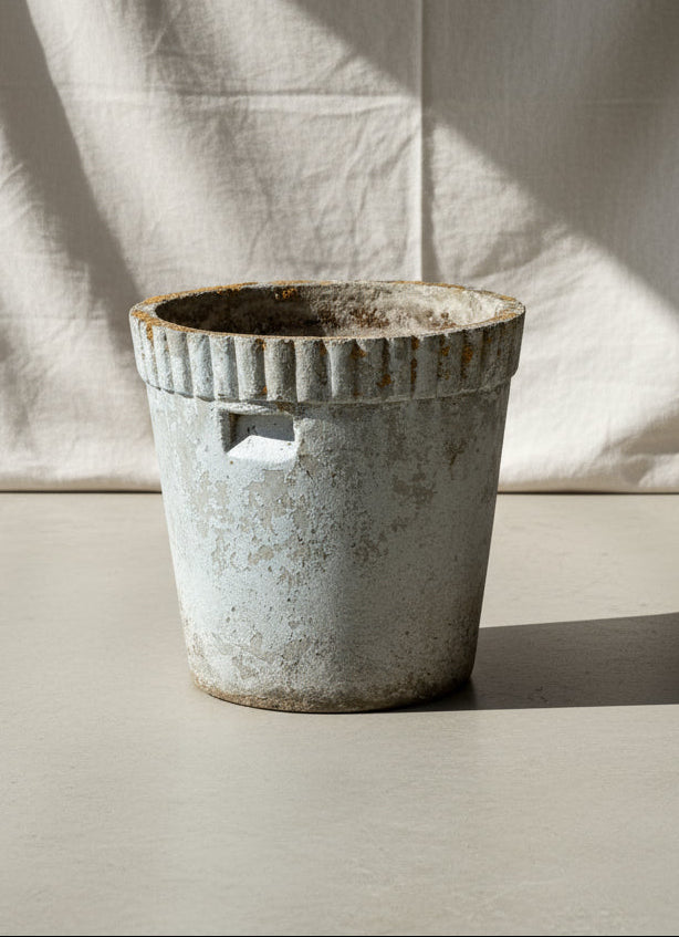 Willy Guhl Flower Pot displayed on a surface, showcasing its mid-century modern cement design, hommes + gardens estudio.