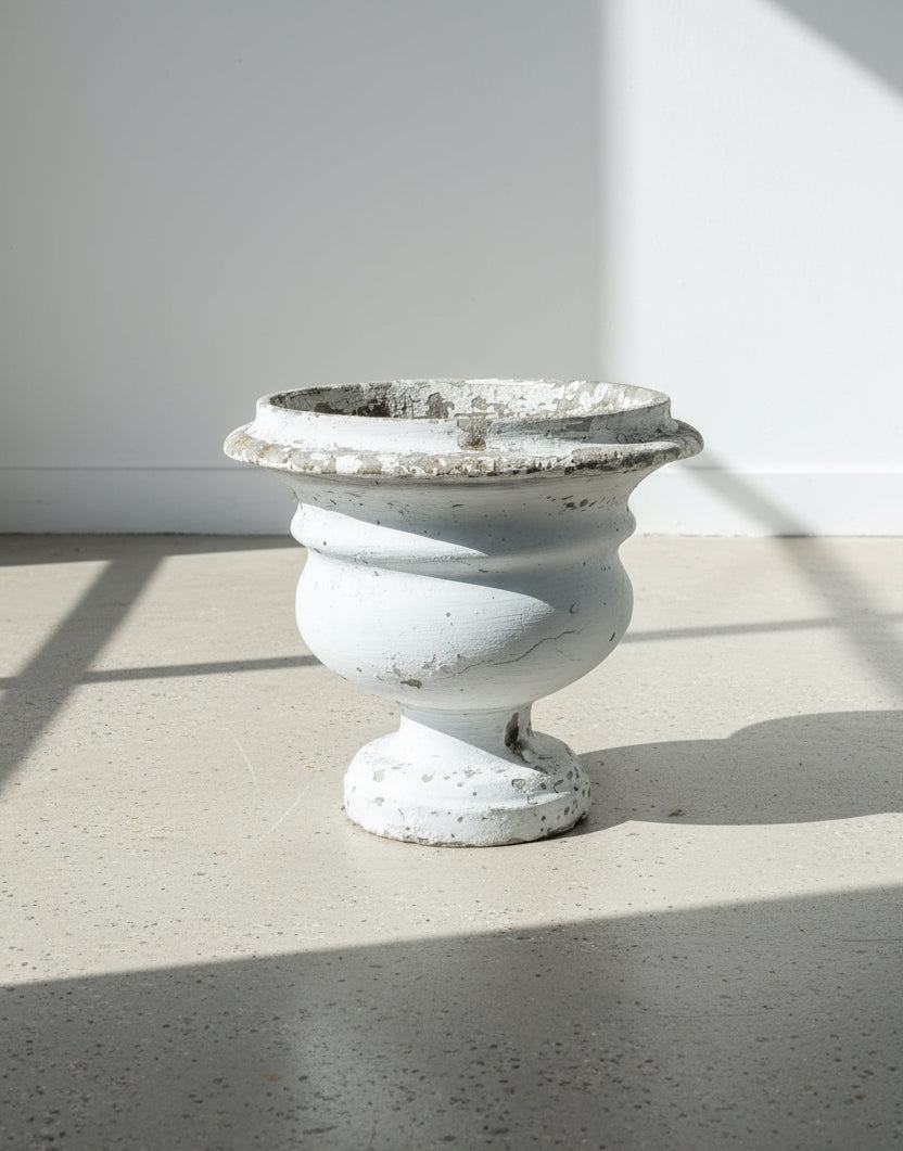 Willy Guhl Vintage Urn 12.5" displayed on light floor with weathered patina, showcasing timeless design. hommes + gardens estudio.