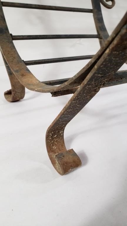 Close-up of the base of the VINTAGE WROUGHT IRON FIREWOOD HOLDER showcasing its sturdy design and rustic finish. hommes + gardens estudio.