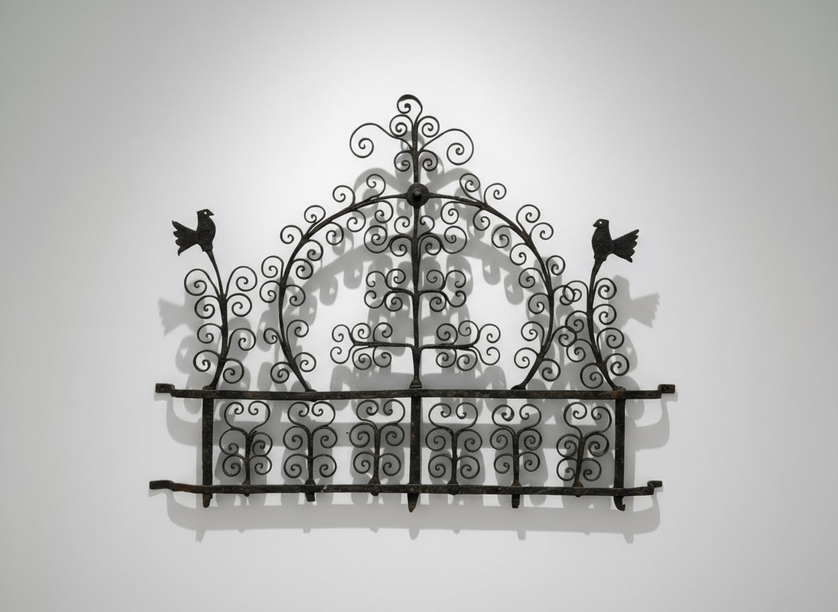 Antique 17th-Century Spanish Style Wrought Iron Wall Rack with Bird Motif showcasing intricate scrollwork and bird designs. hommes + gardens estudio.