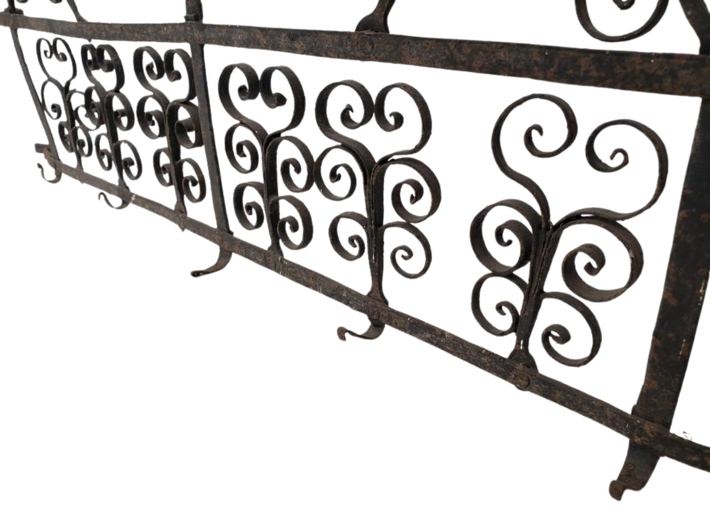 Antique 17th-Century Spanish Style Wrought Iron Wall Rack with Bird Motif showcasing intricate scrollwork and decorative design. hommes + gardens estudio.
