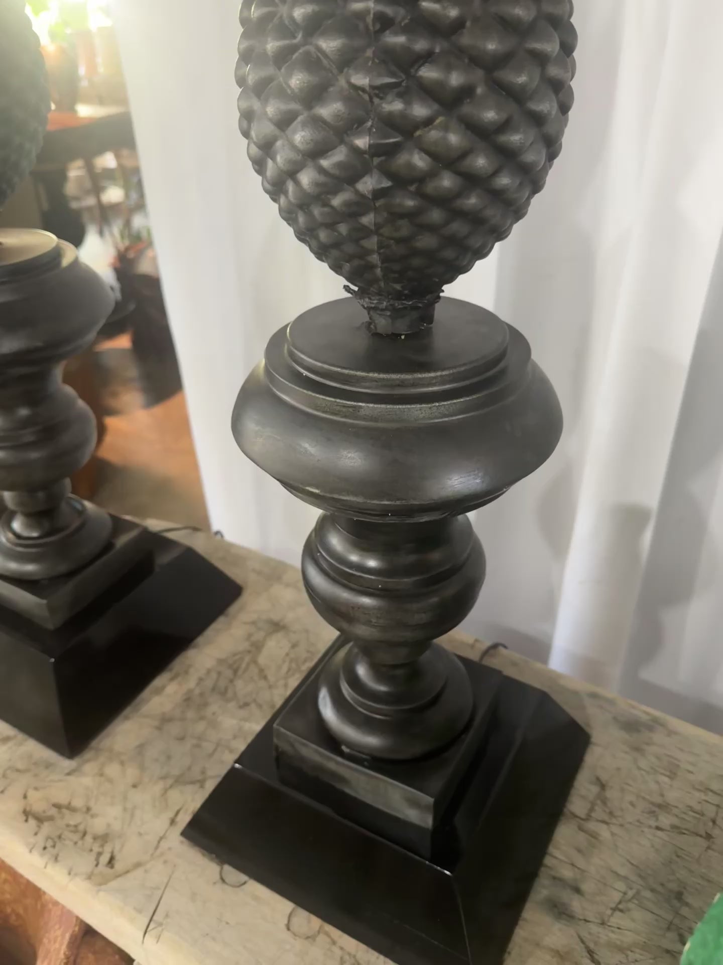 Ornate vintage metal pineapple lamps with black drum shades, restored neoclassical design symbolizing hospitality and timeless elegance — Hommes and Gardens, Lights + Lanterns Collection, Landscape Architect, Interior Designer, Outdoor Living, Art, Furniture, Objects, Best Gifts, Nature, Backyard, Yard, Outdoor Decorations, Home Decor, Home Design, Luxury Design.