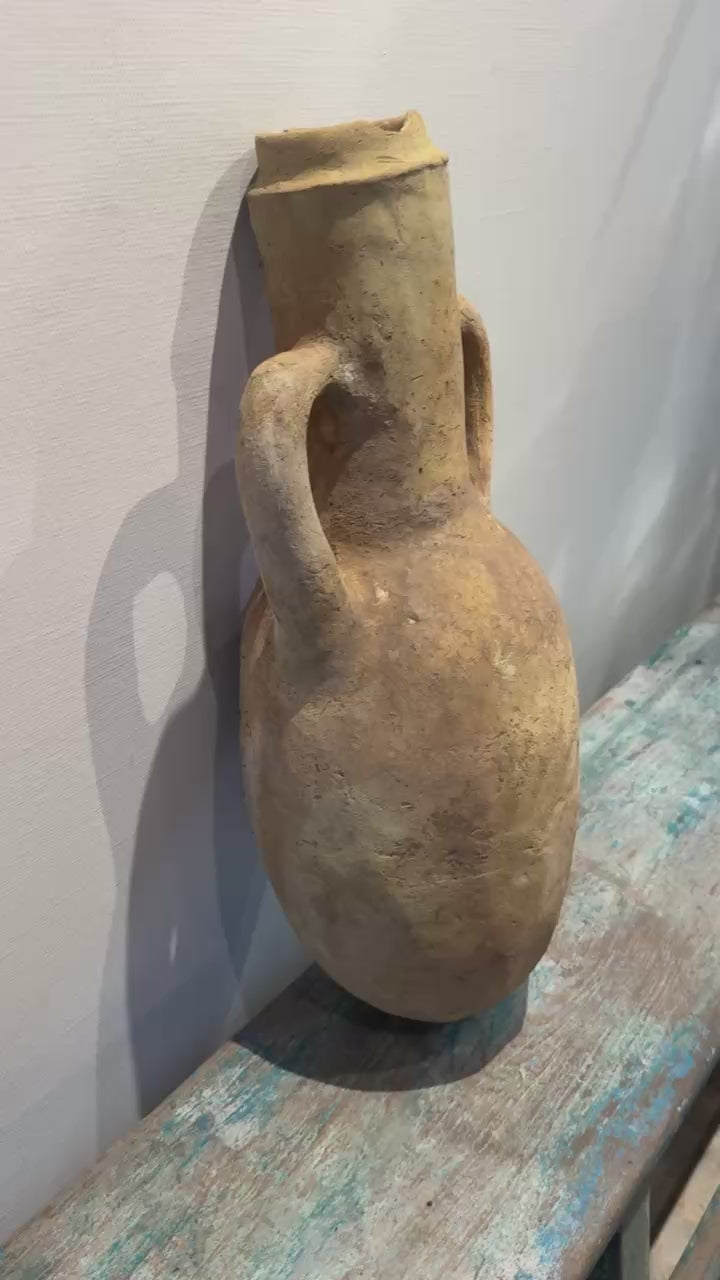 Ancient-Style Mediterranean Terracotta Amphora with Twin Handles and Natural Aged Patina displayed on a rustic surface. hommes + gardens estudio.