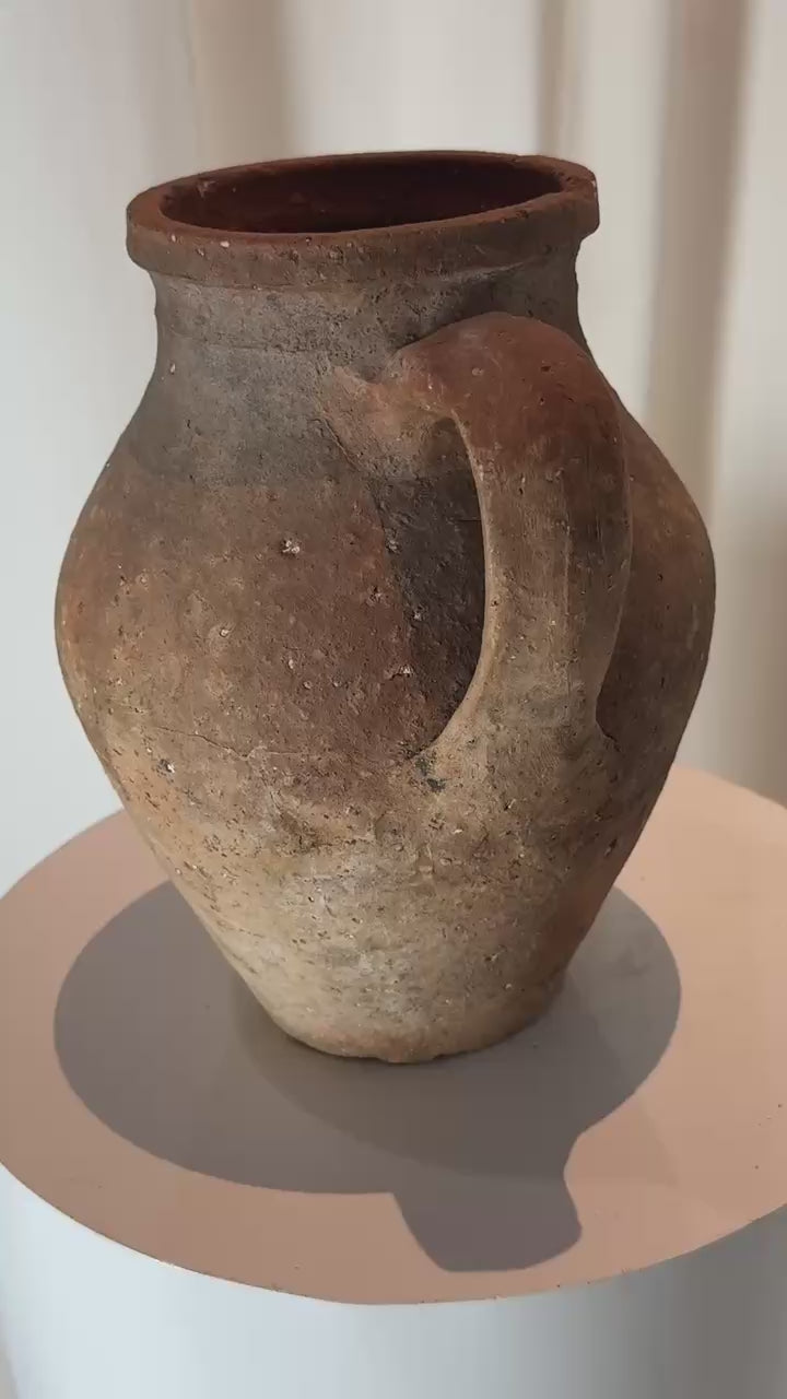 Handcrafted rustic terracotta pot in amphora style with handle and flared rim, antique pottery piece with organic surface and historic charm — Hommes and Gardens, Pots + Planters Collection, Landscape Architect, Interior Designer, Outdoor Living, Art, Furniture, Objects, Best Gifts, Nature, Backyard, Yard, Outdoor Decorations, Home Decor, Home Design, Luxury Design.